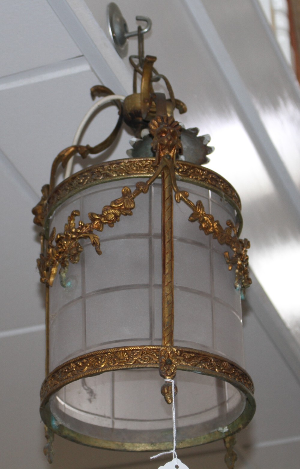 An early 20th century gilt metal and frosted glass hall lantern, drop 42cm, diameter 22cm